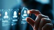© Harry - Professional business person touching a glowing digital mentor icon on a modern blue interface screen in a dark office environment