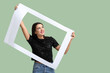 © Pixel-Shot - Beautiful happy young woman with frame on green background