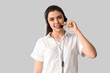 © Pixel-Shot - Female technical support agent on  light background