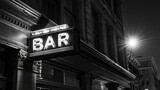 Glowing neon BAR sign illuminating a historical building facade at night, creating an atmospheric city contrast