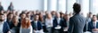 © Kate - Business presenter speaking to corporate seminar audience in modern training room