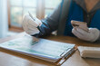 © HappyEva - Digital ESG tracking smart sustainability concept industrial worker in white gloves using smartphone and pointing at net zero environmental report