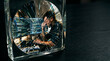 © Arif - Man deep in thought reflected within a crystal cube, visualizing intricate technology and data