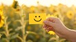 © SemvakCyber - Hand holding a yellow smile icon card for mental health wellness
