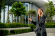 © BGStock72 - Woman talking on phone outside modern building in daylight