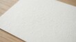 © dewa - Blank Textured Paper Sheet on a Wooden Surface.