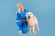 © Prostock-studio - Happy Female Veterinarian Smiling While Kneeling Next To Golden Retriever Dog In Clinic Setting, Providing Care And Attention, Creating Positive Atmosphere For Pet And Pet Owner, Healthcare Concept.