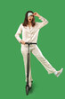 © Pixel-Shot - Shocked young woman in pajamas and sleeping mask with electric scooter on green background