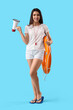 © Pixel-Shot - Female lifeguard with ring buoy and megaphone on blue background