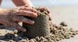 © ManuStockStudio - Gloved Hand Filling a Sandbox with Sand for Construction, Landscaping, and Productivity Planning Outdoor Work and Operational Efficiency