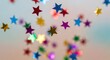© Efan - Colorful Star-Shaped Confetti Falling Against Blue Sky.