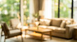 © birulaut - A blurred image of a bright and airy living room featuring a cozy sofa, a wooden coffee table, and large windows that let in natural light.