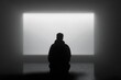 © Ira - Silhouette of caucasian male in minimalist room with bright screen