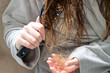 © Anna Kondratiuk - Close-up of a woman holding a clump of lost hair in her hand while brushing her wet hair, concept of hair loss problem and alopecia.Female in a bathrobe holding a hairbrush and shedding damaged hair s
