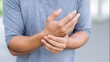 © Bonsales - Person experiencing wrist pain, touching and rubbing forearm. Concept of health issue, injury, arthritis, or carpal tunnel syndrome