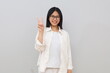 © ArvStd - Happy and beautiful Asian girl smiling, showing two fingers to explain the rules and steps, standing on a white background.