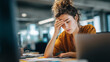 © KotBaton - Exhausted businesswoman working late at a laptop with paperwork, illustrating stress, burnout, fatigue, deadline pressure, mental overload, and modern workplace challenges.