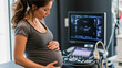 © Alex Alex - A pregnant woman holds her stomach in an ultrasound room, undergoing prenatal examinations and waiting for her baby.