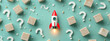 © MDRAFIQUL - Red and white rocket ship with question marks and wooden blocks on blue background.