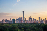 Beijing CBD city skyline with green trees and sunset scenery, China
