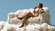 © Wasabi - 雲の上にあるソファに座ってリラックスしながらコーヒーを飲むスーツ姿の男性