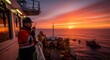 © Margarita Ratatosk - Man onboard an offshore vessel during sunset. Marine engineer communicates through a walkie-talkie. Oil and gas pipeline construction, ocean exploration.