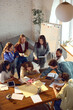 © Lustre Art Group  - Startup team brainstorming product ideas from top view in office. Concept of collaborative planning, creative workflow, business strategy, design sprint, team productivity.
