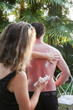 © Luciano Spinelli/Stocksy - Applying Sunscreen to sunburn person