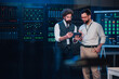 © Zamrznuti tonovi - It engineers collaborating on digital tablet in server room, managing cloud computing and network infrastructure