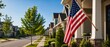 © Olga Ко - American flag waving hanging on a porch in a typical US suburban neighborhood. 4th of July Independence Day, Memorial Day, Labor Day, and Veterans Day celebratory concept banner