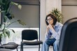 © Maria Vitkovska - Sad upset woman thinking, waiting in office hallway before meeting