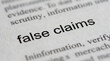 © MD - Close-up of dictionary page with false claims definition, misinformation concept