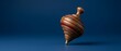 © Sekodong - Vintage Wooden Spinning Top Toy with Copy Space on Blue Background