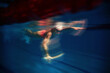 © master1305 - Swimmer gliding underwater with artistic motion blur effect. Concept of anonymous sport poster, speed and motion blur, athletic competition, sports energy background.