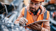 © Denis Yevtekhov - Young engineer in safety helmet checking ore fraction near a quarry conveyor, clipboard and protective gear, quality control, mining engineer, ore inspection, quarry control, industrial