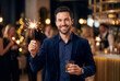 © Meow Creations - Smiling man holding sparkler and drink at evening party