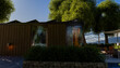 © Connect Images - Modern wooden cabin surrounded by lush trees under a clear blue sky.