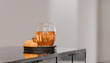 © Connect Images - Glass teapot with warm tea and lemons on a black tray in a modern kitchen setting.