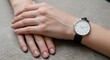 © Nabila - Woman's wrist wearing elegant minimalist analog watch with black leather strap