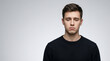 © farid - Sad and depressed young man looking down with disappointed facial expression,