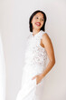 © Tania Cervian/Stocksy - Woman smiling wearing white lace top