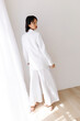 © Tania Cervian/Stocksy - Woman in white blazer and wide-leg trousers