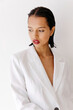 © Tania Cervian/Stocksy - Woman in white blazer looking down