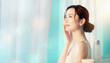 © noonekoon - Asian woman looking away with gentle smile in refreshing background 爽やかな背景の中で優しく微笑みながら横を向くアジア人女性