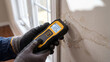 © AiDesign - Moisture meter device reading damp wall concept for water damage detection and home inspection including humidity testing and property maintenance diagnostic tool