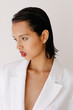 © Tania Cervian/Stocksy - Woman wearing white blazer and wet hair look