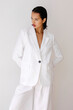 © Tania Cervian/Stocksy - Woman modeling white linen suit