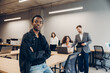 © Maria Vitkovska - Young black man posing in modern office working with team