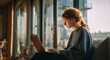 © MysticHaven - woman sitting on couch with laptop in front of large window with city view outside during daytime wi