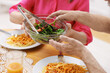 © New Africa - Lovely senior couple having dinner together. Woman passing bowl of salad to her husband at table, closeup